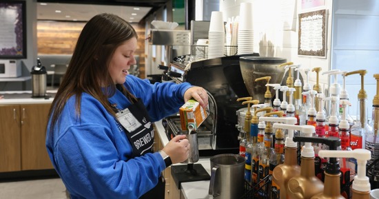Manager Becca Koch works behind the counter at Brewed Awakening, a student-run coffee shop on the UNK campus. (Photo by Erika Pritchard, UNK Communications)